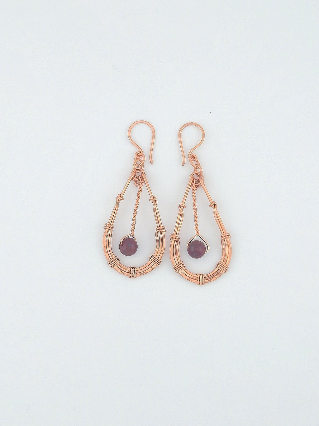 Handcrafted hammered copper teardrop earrings with pink tourmaline gemstone by Willow Tree Studio.