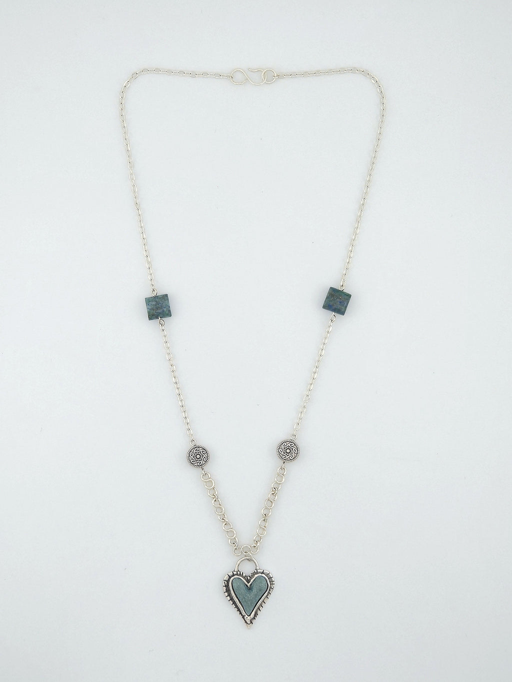 Handcrafted Tibetan-style heart necklace with teal accents and silver artisan chain by Willow Tree Studio.